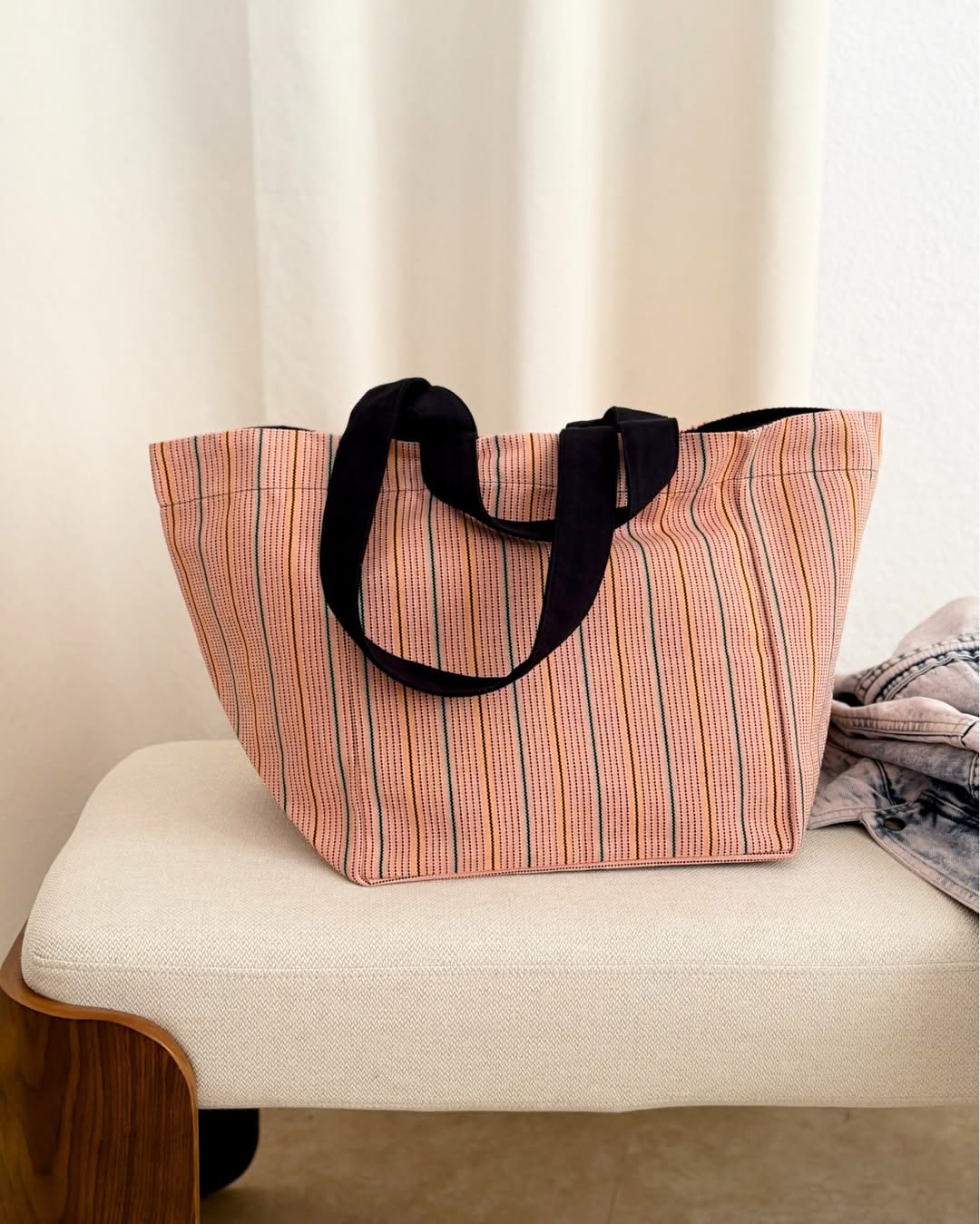 Large carry shoulder bag1 made from 1897 No.1 fabric, showing woven vertical stripes in soft pink, red, beige, and cream tones with a textured linen-cotton weave. Made by Les Toiles du Soleil