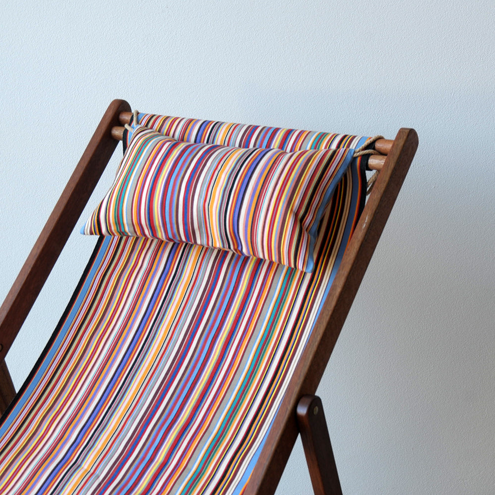 ici et la dechkchair with head cushion with Tom Multi fabric featuring a multicoloured striped pattern with various bands in different colours, indicating a vibrant and lively design. By Les Toiles du Soleil
