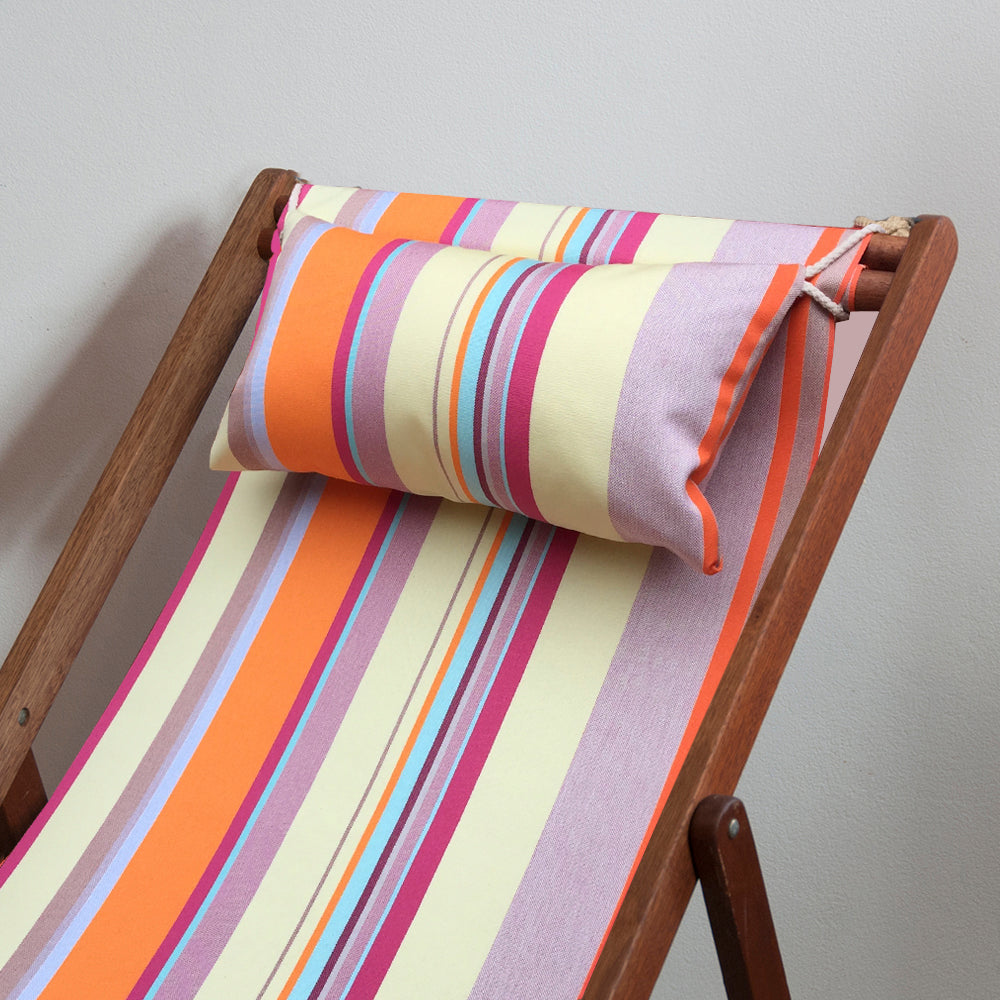 Wooden ici et la deckchair with head cushion featuring pinks, soft yellows, teal and orange striped fabric