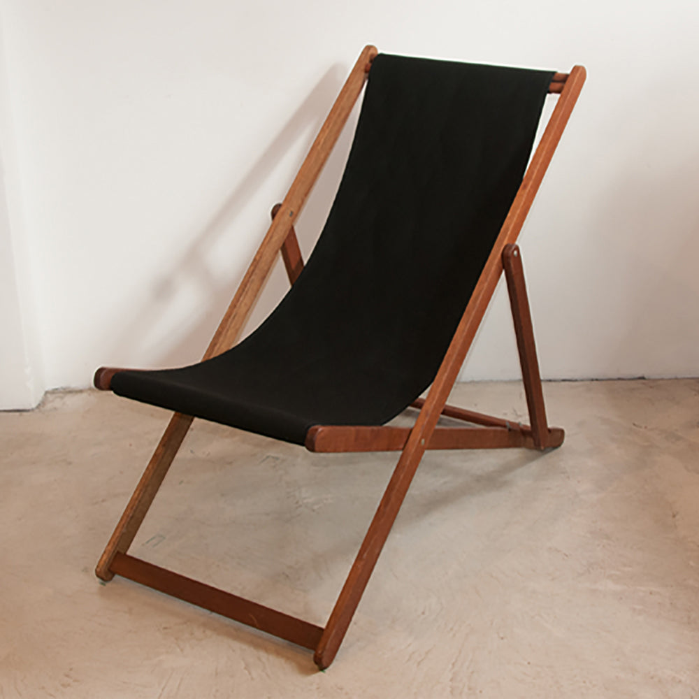 Black Sunbrella fabric sling on ici et la wooden deckchair