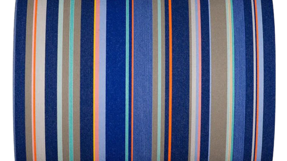 St Vincent Roy a striped Les Toiles du Soleil cotton fabric featuring a deep navy ground with varied stripes of cobalt blue, warm taupe/khaki, silver grey, turquoise, orange and soft pink/peach accent lines.