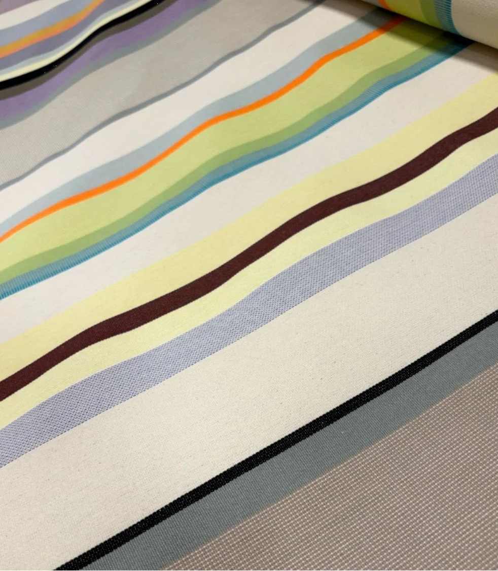 Close-up of a fabric with st colombe multicoloured stripes on a textured surface.
