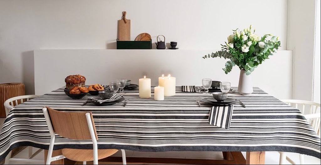 Tablecloth made from cotton fabric by Les Toiles du Soleil called Tom Black. A multi striped pattern of white and black - like a barcode