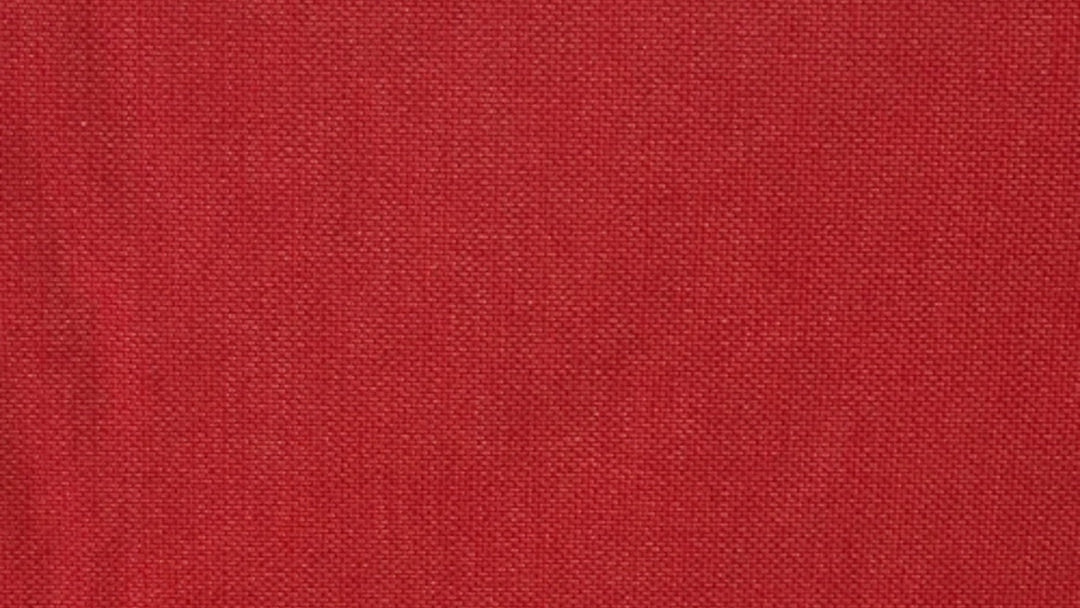 A close-up image of a red indoor 100% otton fabric by Les Toiles du Soleil with a textured weave pattern.