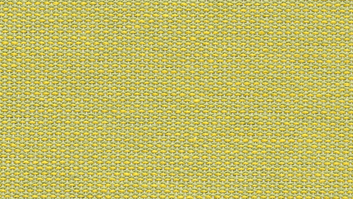 A close-up of a vibrant anis yellow acide Les Toiles du Soleil 100% cotton fabric, solid-patterned indoor cotton fabric.