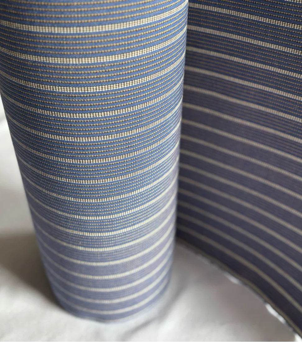 Close up of 1897 no.9 43cm cotton fabric roll by Les Toiles du Soleil. Featuring blue and light stripes with detailed weave by Les Toiles du Soleil