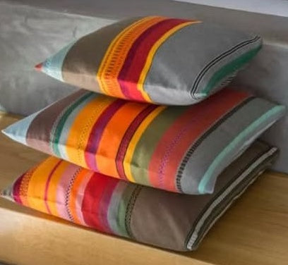 Cushions made from Les Toiles du Soleil Arles sur Tech multi coloured grey, red, yellow and orange fabric