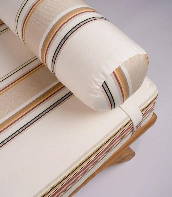 lounge bed with head pillow made of 100% cotton fabric roll by Les Toiles du Soleil. Auguste range with multiple coloured stripes of light browns, soft, beige and pinks, and other colours