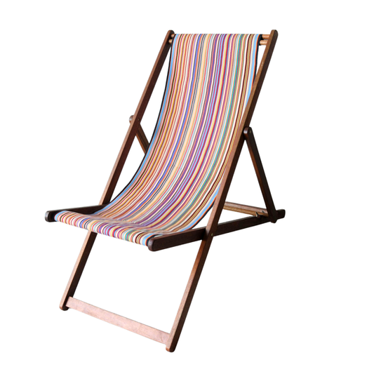 Hardwood folding deckchair featuring Tom Multi cotton Les Toiles du Soleil multi-coloured and striped fabric. Feating 35 colours. On a white background.