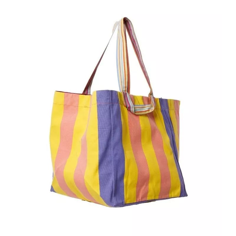 Shoulder carry bag made with Carthage Jaune Rode - a fabric featuring a striped pattern with vibrant yellow, rose and klein blue. A detailed 100% cotton weave by By Les Toiles du Soleil