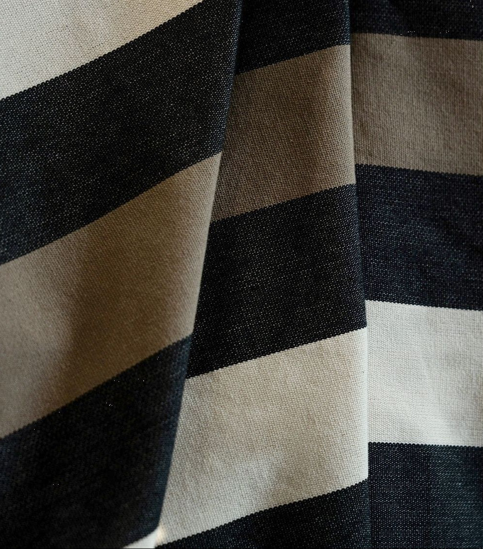Close up of Boulevard Raspail Taupe 100% cotton Les Toiles du Soleil 180cm with black, brown and neutral multi striped 