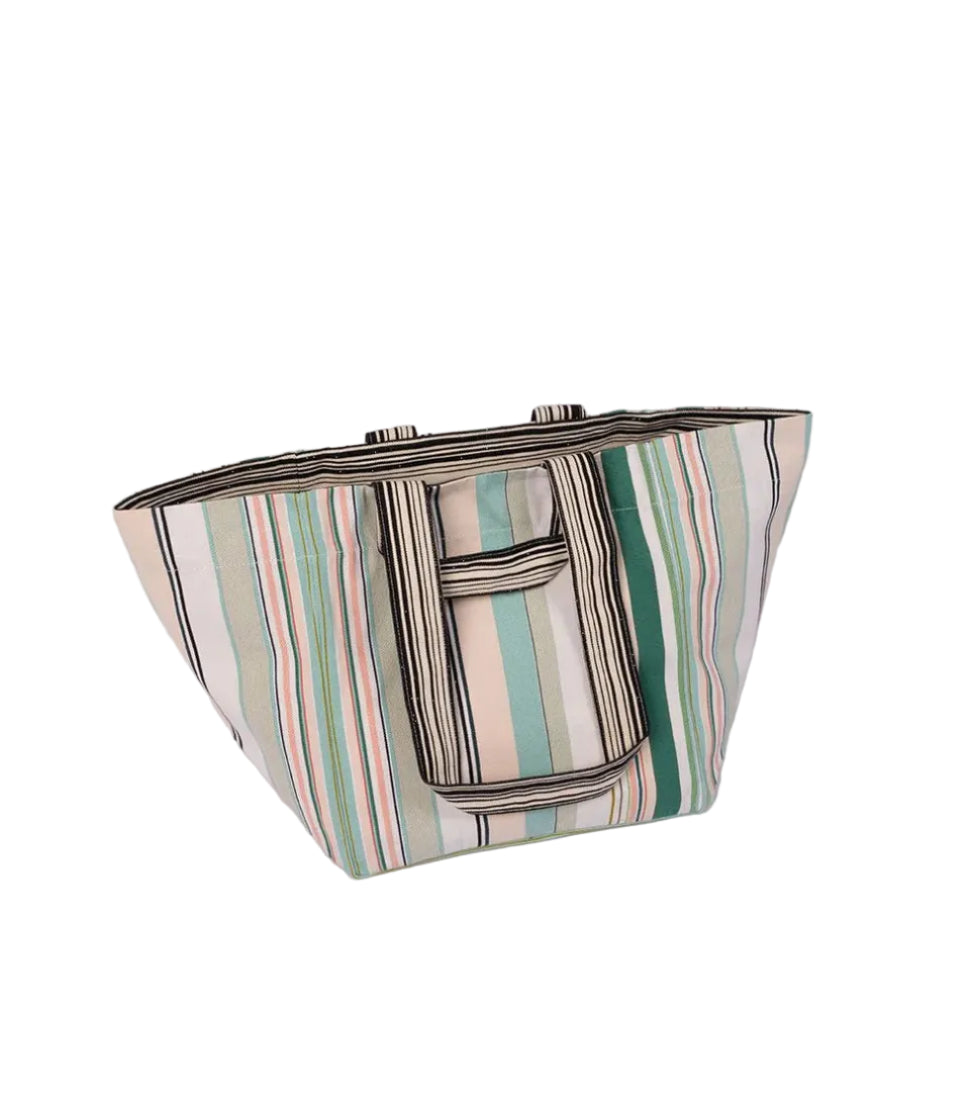 Large shoulder bag made from Bompas cotton fabric by Les Toiles du Soleil. Featuring soft hues of striped greens, turquoise, blush pink and white. Placed on a white background
