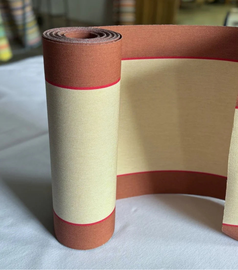 A rolled cotton fabric featuring a wide warm écru centre stripe flanked by broad terracotta bands, with a fine crimson accent line between them.
