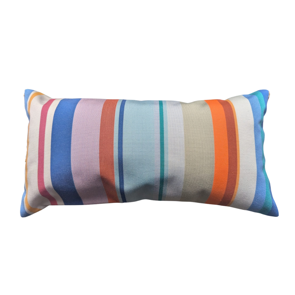 A rectangular lumbar throw pillow with a vibrant multicolor striped pattern featuring vertical bands of blue, pink, orange, teal, and beige on a white background.