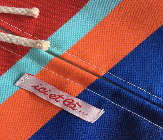 Close up of colourful ici et la and Les Toiles du Soleil striped fabric