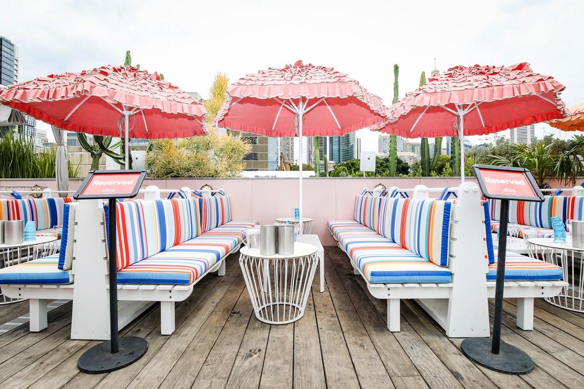 Slims, Sydney, roof top bar with colour striped ici et la custom Les Toiles du Soleil and Sunbrella seat cushions