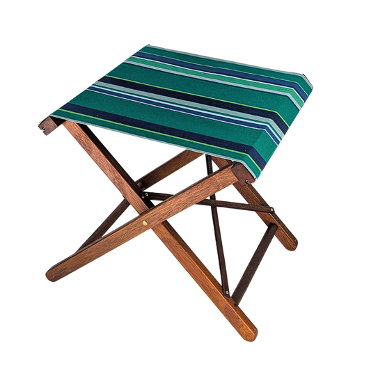 Hardwood folding stool with cotton fabric featuring bold stripes in deep teal, turquoise, and multiple shades of blue and green. On a white background