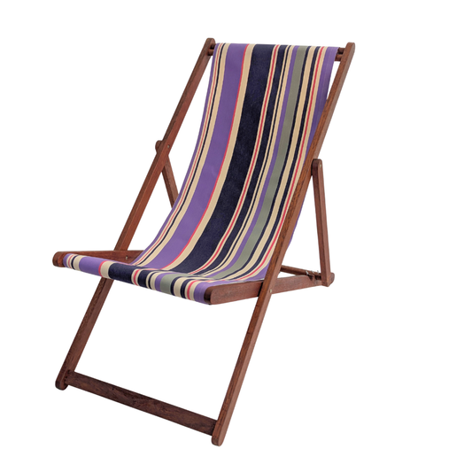 A wooden folding deck chair with a striped fabric sling in purple, navy, cream, crimson, and grey shown on a plain white background.