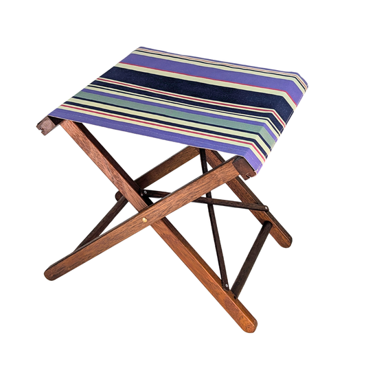 Hardwood folding stool showcasing cotton fabric with navy, violet, and ivory stripes accented by fine crimson lines.