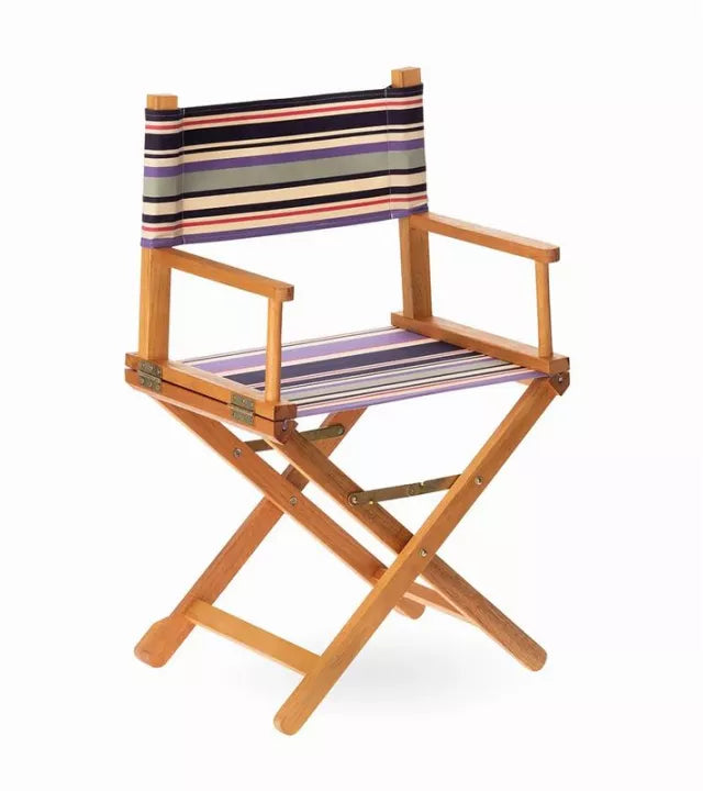 Wooden director's chair with fabric featuring navy, violet, and ivory stripes accented by fine crimson lines. On a white background