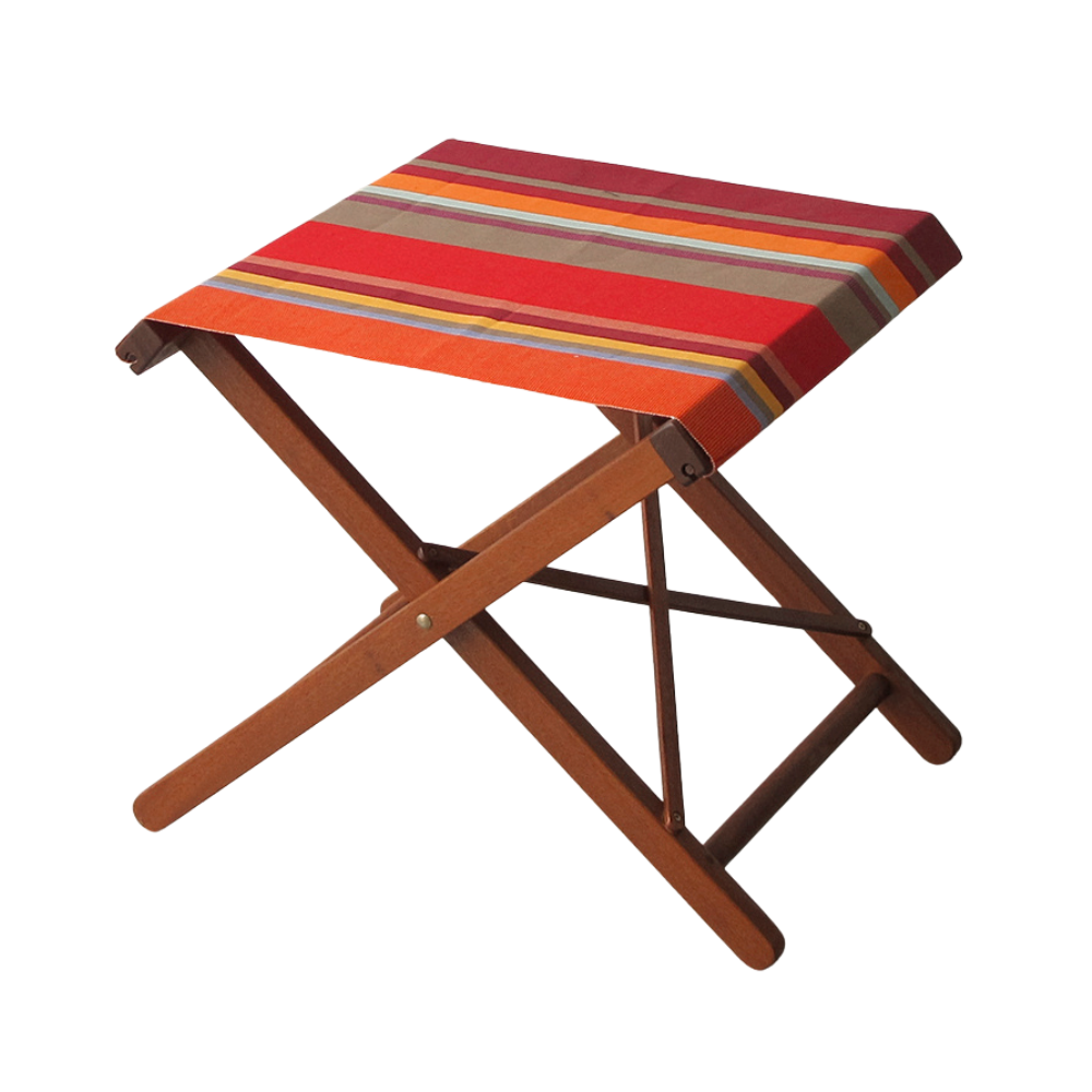 Ici et la hardwood folding stool made from Collioure Rouge - a fabric featuring a striped pattern with various bands in reds, orange, taupe, burgundy, turquoise, and other vibrant colours. A detailed 100% cotton weave by By Les Toiles du Soleil