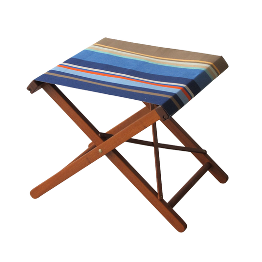 Ici et la hardwood folding stool made from Collioure Roy - a fabric featuring a striped pattern with various bands in different shades of blue, beige, brown and red. A detailed 100% cotton weave by By Les Toiles du Soleil 