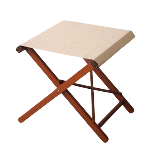 Hardwood folding stool with natural coloured Les Toiles du Soleil cotton fabric.  On a plain background