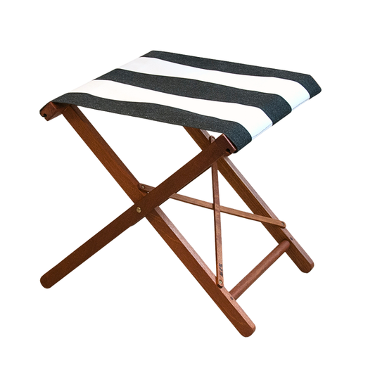 A folding stool with a hardwood frame and synthetic block stripe seat in charcoal and white colours.