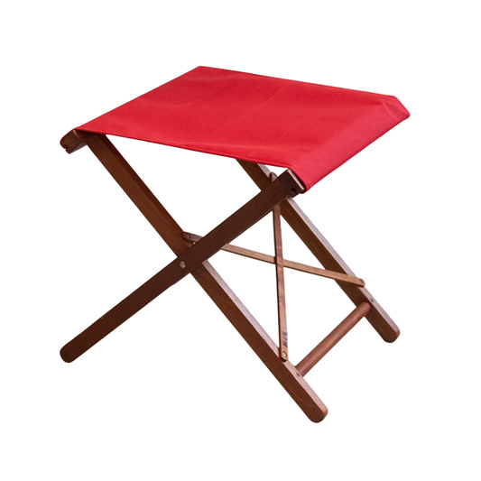 A folding stool with a hardwood frame and a solid red synthetic fabric seat.