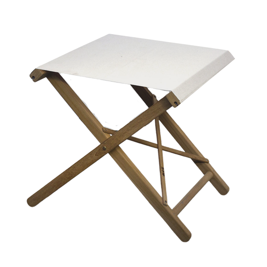 A folding stool with a teak frame and a white synthetic fabric seat, displayed against a plain background.