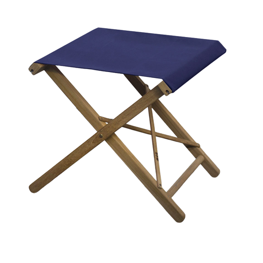 A teak folding camp stool with a navy blue subrella outdoor canvas seat shown on a plain white background.