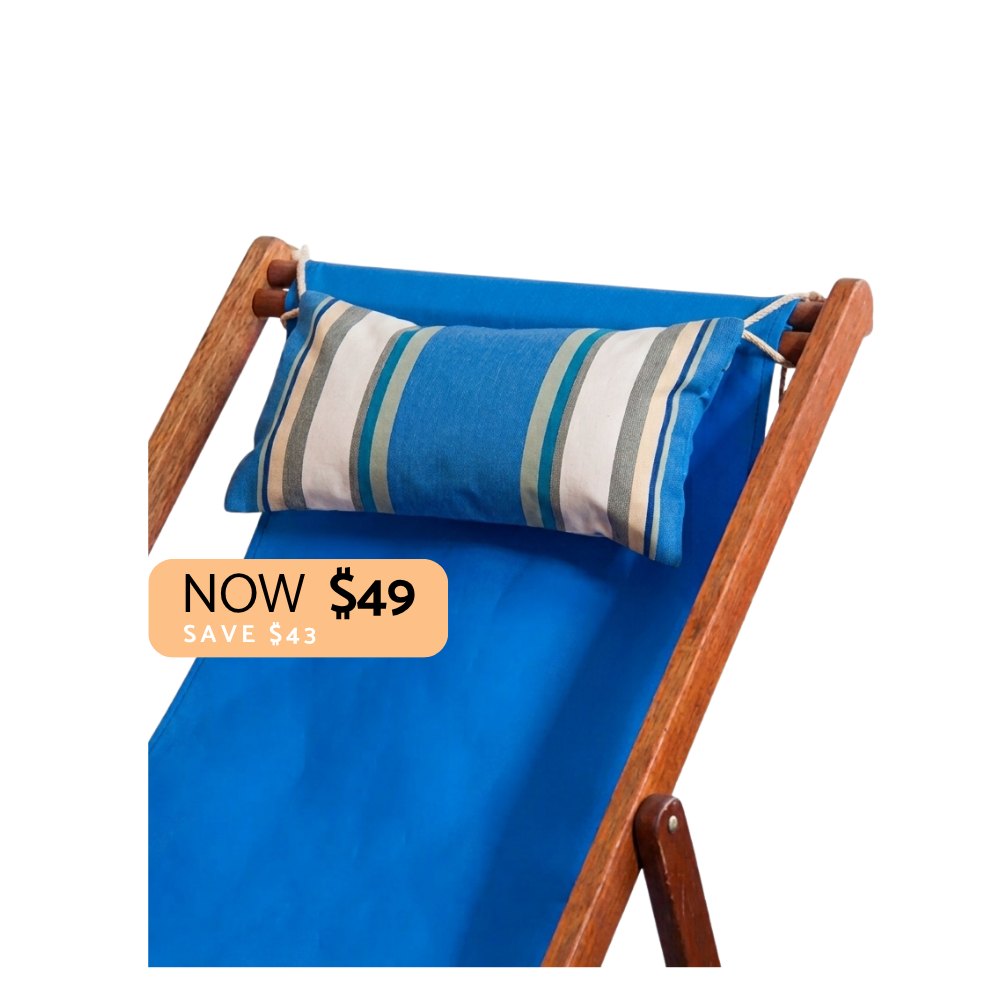 Blue, white green and grey striped head cushion on a blue deckchair. Plain background