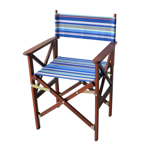 A hardwood folding director's chair with a brown hardwood frame and hues of blue, orange, grey, and pink striped synthetic fabric seat.