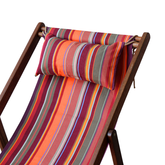 Ici et la deckchair and head pillow in 43cm cotton Fabric in St Vincent Rouge, featuring a multicoloured striped pattern with various bands in reds, orange, purple, browns and different colours, indicating a vibrant and lively design. By Les Toiles du Soleil