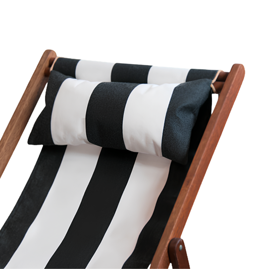 Sunbrella charcoal and white striped head cushion placed on a matching striped deckchair by Ici et la