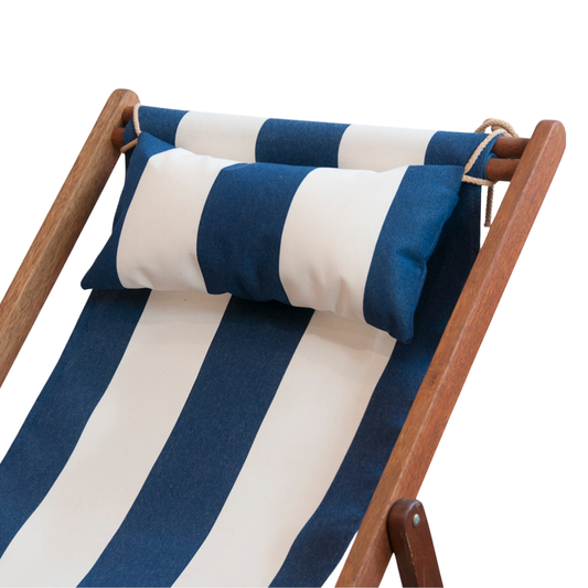A navy blue and cream striped head cushion on a wooden deckchair, with a striped pattern matching the cushion.
