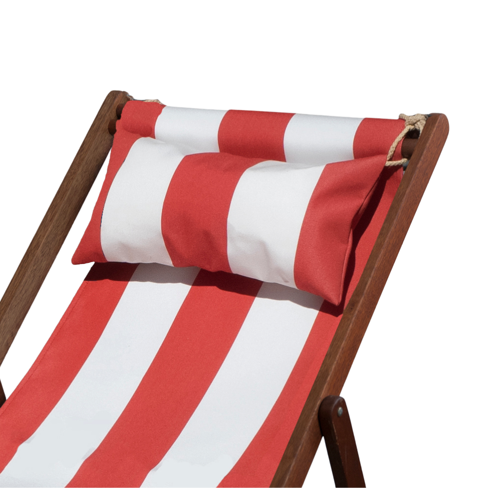 Sunbrella red and white striped head cushion placed on a matching striped deckchair by ici et la