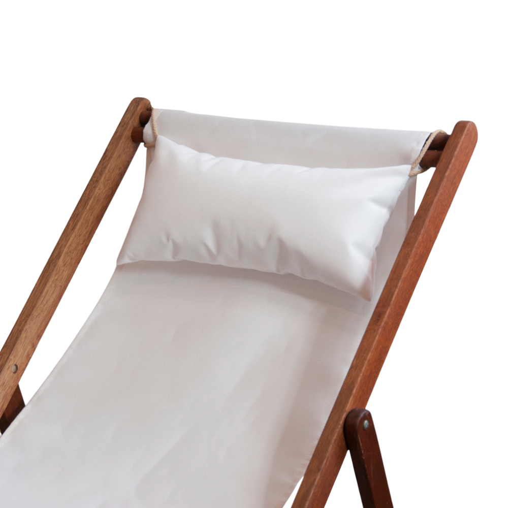 Hardwood folding deckchair with a close up of a head cushion resting on the matching fabric featuring white outdoor Sunbrella fabric. On a white background