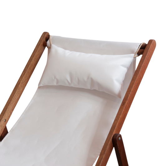 Hardwood folding deckchair with a close up of a head cushion resting on the matching fabric featuring white outdoor Sunbrella fabric. On a white background