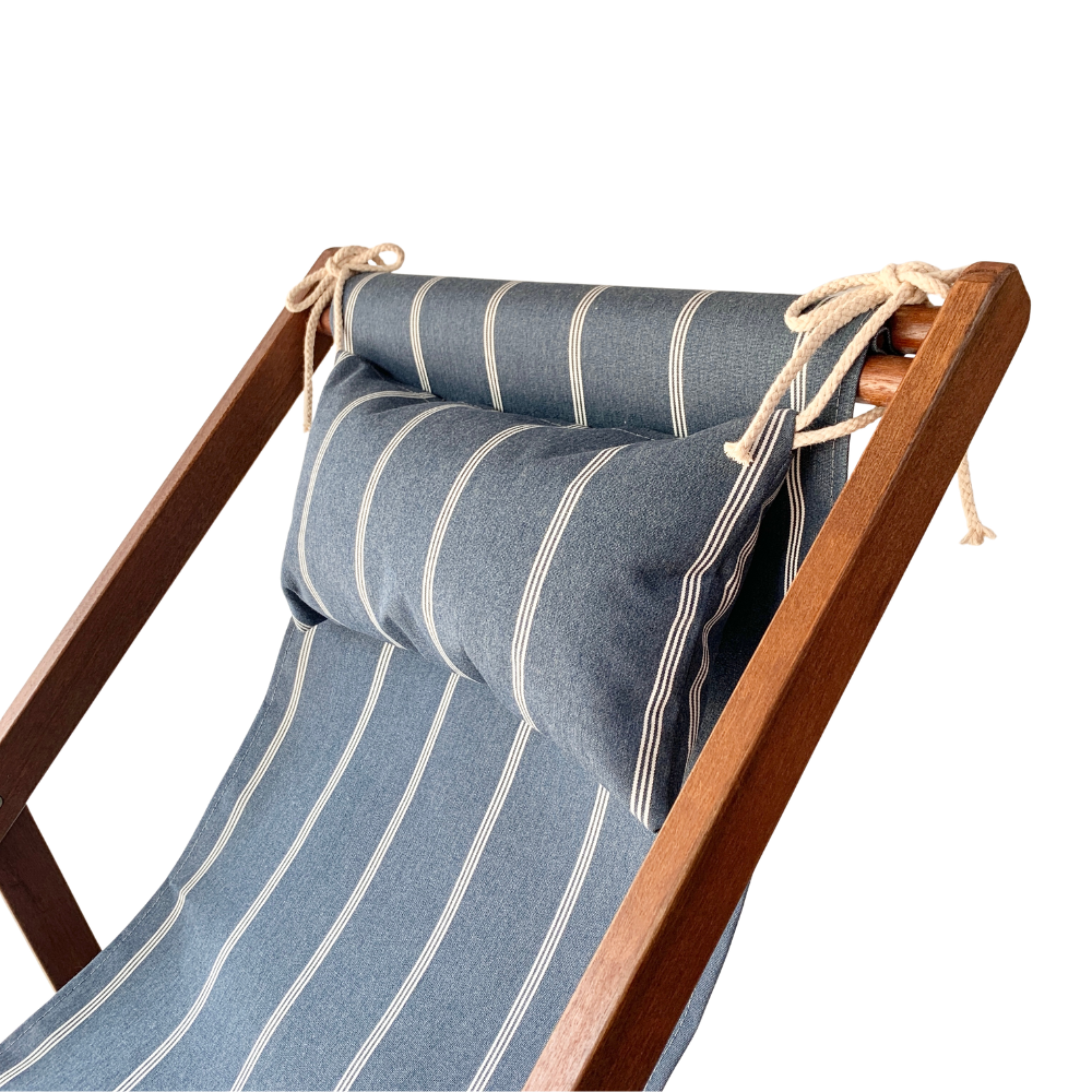 A close-up of a wooden deck chair with blue striped cushions, including a backrest cushion and seat cushion, tied securely with rope.