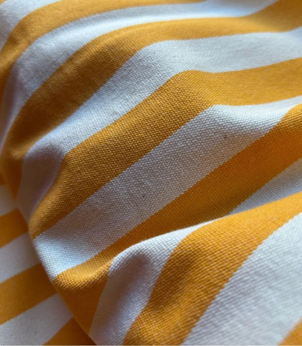 Close up of Isola Bella saffron & ecru striped 100%cotton Fabric by Les Toiles du Soleil
