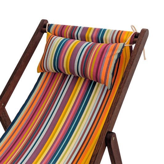 A wooden folding lounge chair with a colourful striped fabric sling of 35 different colours and matching striped headrest pillow, shown on a plain white background.