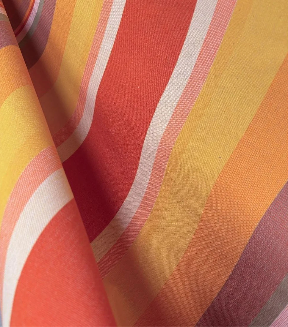 Close up of L'Apricot 100% cotton fabric by Les Toiles du Soleil. Warm coloured textured woven striped fabric