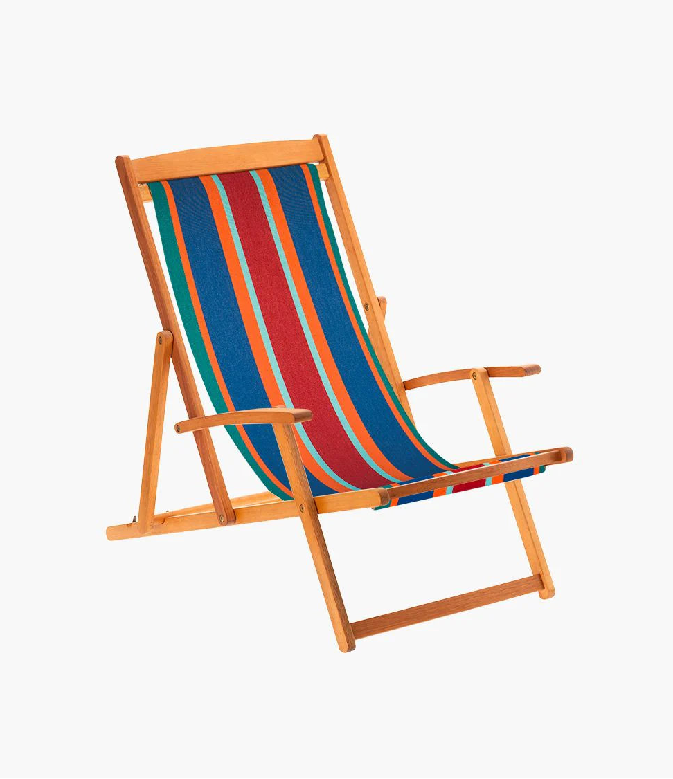 Deckchair featuring bold striped cotton fabric featuring red, turquoise , orange, blue and teal. Made by Les Toiles du Soleil. 
