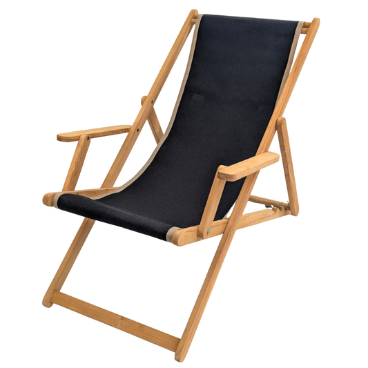 Teak deckchair with arms featuring a cotton Les Toiles du Soleil fabric of solid black with beige border on edges, on a white background.