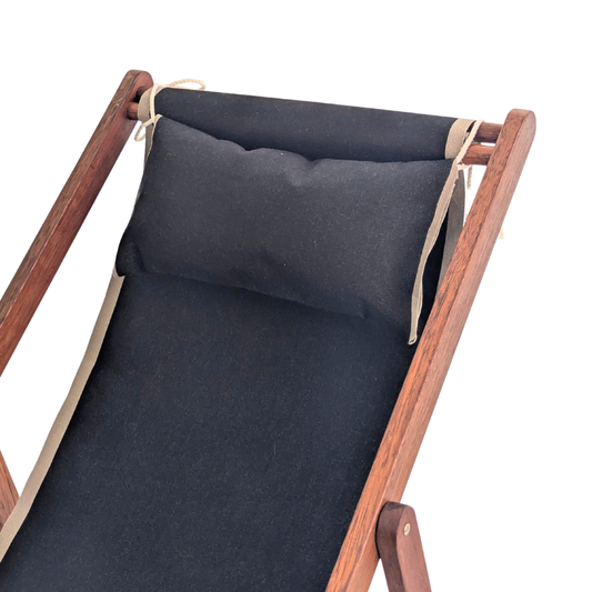 Hardwood deckchair with a matching head cushion in Cotton 43cm Les Toiles du Soleil fabric in 43cm featuring black with taupe coloured edges. On a white background