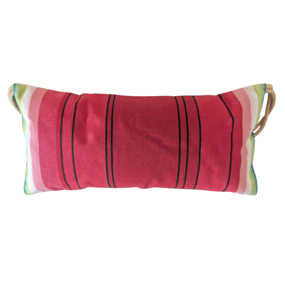 Watermelon colours in multi stripes head cushion on a red deckchair sling. Plain background