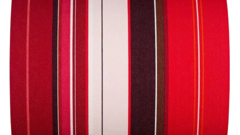 Petit Rue du Bac ROuge is a cotton fabric roll featuring bold stripes of bright red, deep burgundy, soft blush and dark chocolate brown, with fine white and orange accent lines. Made by Les Toiles du Soleil
