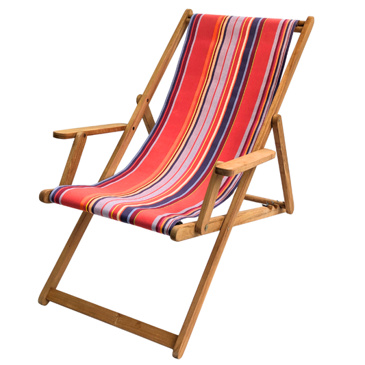 Teak deckchair with arms featuring a cotton Les Toiles du Soleil fabric of multi-striped lilac, purple, red, and yellow, on a white background.
