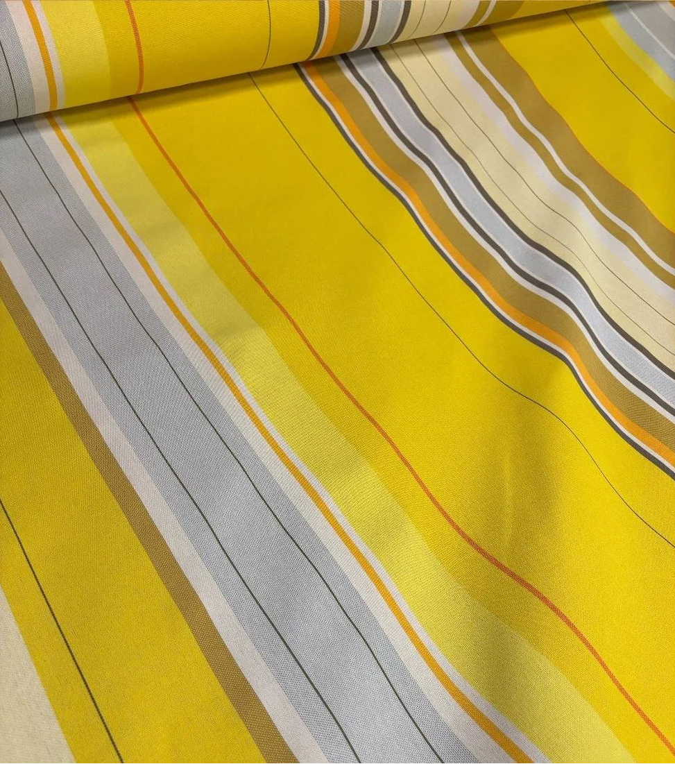 Close up of Plein Soleil multi coloured yellow, grey, and sun toned striped Les Toiles du Soleil 100% cotton fabric. 